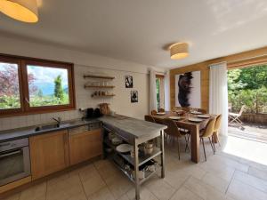 a kitchen with a table and a dining room at Appartement spacieux et lumineux, 3 chambres, proche centre Les Gets, terrasse, parking, calme. - FR-1-598-167 in Les Gets