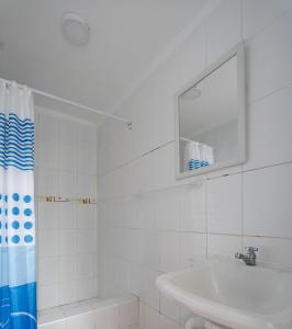 a white bathroom with a sink and a mirror at Casa Nutria - Pucusana Las Ninfas - Beach and Sea in Pucusana +65 photos