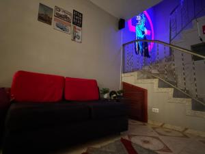 a living room with a couch and a stage at Gato Neon Hostel in Bogotá