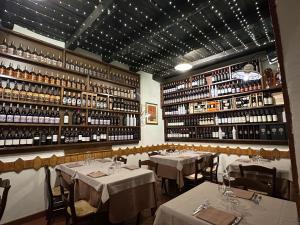a dining room with tables and shelves of wine bottles at Mirellas dream in Vibo Valentia