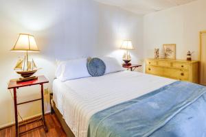 a bedroom with a large bed with two lamps on tables at Mays Landing Rental on Great Egg Harbor River! in Gravelly Run