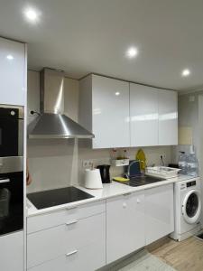a kitchen with white cabinets and a stove top oven at sony Rooms in Lisbon +1 photo