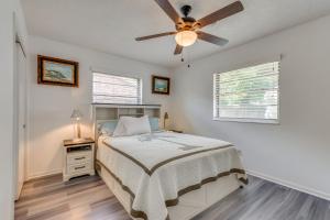 a bedroom with a bed and a ceiling fan at Swim, Golf and Relax! Kokomo on the Emerald Coast in Pensacola +17 photos