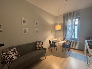 a living room with a couch and a table at Apartments via Roma in Rovereto
