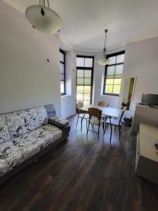 a living room with a couch and a table at Balkan Aparts in Hisarya