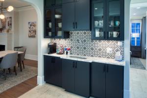 a kitchen with blue cabinets and a dining room at Luxury Villa 3 BR w Private Bath Walk Everywhere in Savannah