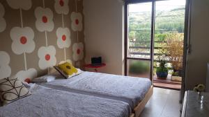 a bedroom with a bed and a window with a view at El Crucero in La Magdalena