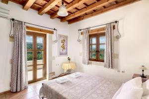 a bedroom with a bed and a window at Arodamos Villa with a pool, children's games, and BBQ, perfect for 23 people! in Skouloúfia