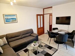 a living room with a couch and a table at Drive & Stay Korčula in Korčula