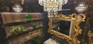 a mirror and a chandelier in a room with plants at Diamond class 2 Hanza Tower in Szczecin +16 photos