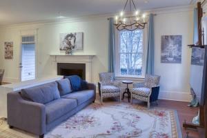 a living room with a couch and a fireplace at Updated Historic Villa 3 BR suites Walk Everywhere in Savannah +48 photos