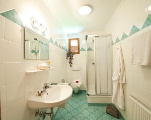 a white bathroom with a sink and a shower at Ferienwohnung Hartlbauer In Dorfgastein in Dorfgastein