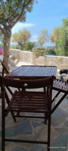 a wooden table sitting on top of a bench at OrkiSEA-Orkos beach in Mikri Vigla