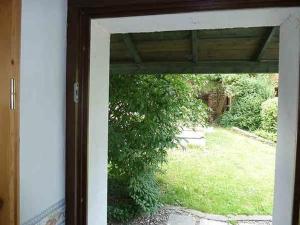 an open door with a view of a yard at Ferienwohnung Lotti in Brotterode-Trusetal +25 photos