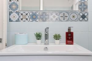 a bathroom sink with three plants on it at Casa Storica a San Terenzo in San Terenzo