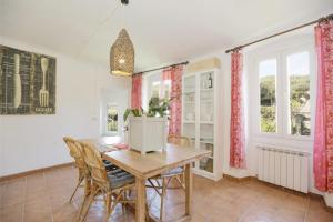 a dining room with a wooden table and chairs at Casa Storica a San Terenzo in San Terenzo