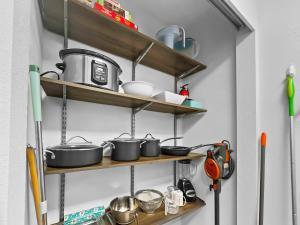 a bunch of pots and pans on shelves in a kitchen at Park City Gem at Red Pine! Cozy Ski Condo with Heated Pools and Hot Tubs! B4 by SkyRun Park City in Park City