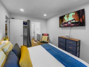 a bedroom with a bed and a tv on the wall at Park City Gem at Red Pine! Cozy Ski Condo with Heated Pools and Hot Tubs! B4 by SkyRun Park City in Park City