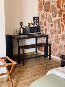 a table with a microwave on it in a room at El Callejón HIERRO in Real de Catorce