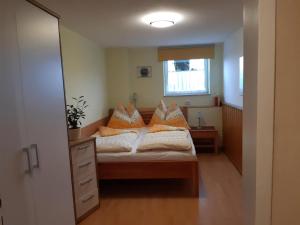 a bedroom with a bed with pillows on it at Haus Dreier in Abtenau +20 photos
