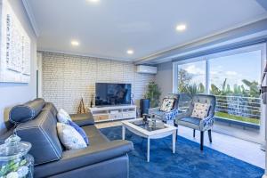 a living room with a couch and two chairs and a tv at Casa da Fonte by YOUR KEY - 1st floor house in Ribeira Brava