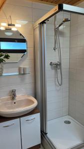 a bathroom with a sink and a shower at Ferienhaus Maria in Nagel +10 photos