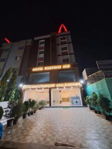 a building with a sign in front of it at night at Fortune inn Hotel and restaurant in Alandi