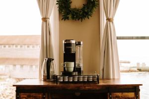 a table with a coffee maker and a cup on it at Albert's in Shelburne