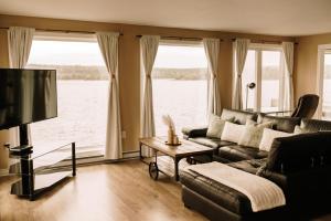 a living room with a couch and a large window at Albert's in Shelburne