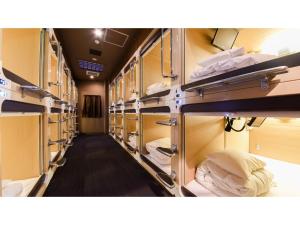 a train room with many bunk beds in it at Tanegashima Araki Hotel - Vacation STAY 48538v in Nishinoomote