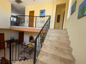 a spiral staircase in a home with a stair case at San Felipe Luxurious 3-Bedroom Condo 11-3 with Pool Access in La Ponderosa