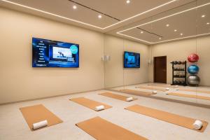 a yoga room with a flat screen tv and yoga mats at Kimpton Atlantico Algarve by IHG in Albufeira