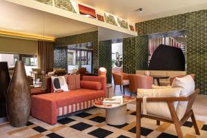 a living room with a couch and chairs at Kimpton Atlantico Algarve by IHG in Albufeira