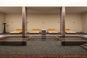 a row of beds in a large room at Kimpton Atlantico Algarve by IHG in Albufeira