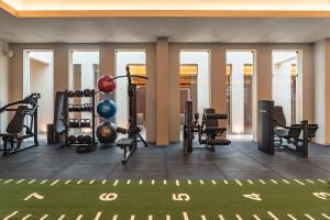 a gym with cardio equipment in a building at Kimpton Atlantico Algarve by IHG in Albufeira