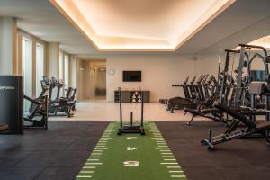 a gym with treadmills and elliptical machines at Kimpton Atlantico Algarve by IHG in Albufeira