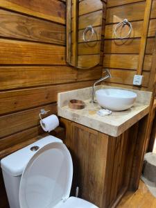 a bathroom with a toilet and a sink at Natural Harmony Bungalow in Baturité