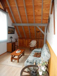 a living room with a couch and a table at Les hauts du Schliffels in Fellering