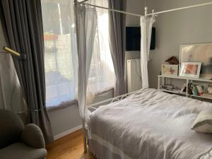 a bedroom with a canopy bed and a window at Ferienwohnung Reeker in Kiefersfelden