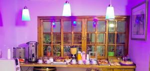 a kitchen with a counter with cups and a cabinet at Castelar in Mendoza +4 photos