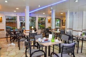 a restaurant with tables and chairs in a room at Castelar in Mendoza