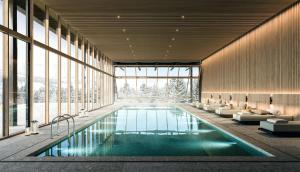 a swimming pool in a building with windows at One&Only Moonlight Basin in Big Sky