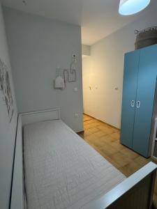 a room with a bed and a blue cabinet at Koroni Dream House in Koroni