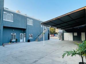 a large blue building with a ramp leading into it at Casa Rayón 2 in Tuxpan