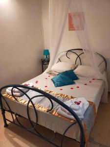 a bedroom with a bed with red flowers on it at Maison conviviale à Fort-de-France avec terrasse in Fort-de-France
