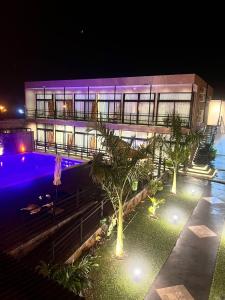 a large building with a swimming pool at night at Paraiso Natural Apart & Hotel Iguazu in Puerto Iguazú