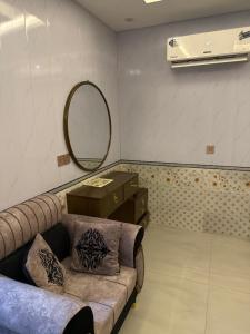 a living room with a couch and a mirror at Nizami menzil house in Dargai