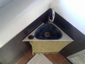 a blue sink in the corner of a bathroom at Las Lucías, experiencias de ecoturismo in Navatrasierra +42 photos