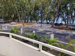 a white fence next to a parking lot at Pearl villa in Flic-en-Flac +7 photos