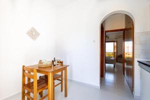 a kitchen with a wooden table and a dining room at Horizon Studios Afitos in Afitos